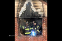 Firefighters at a window during fire operations in Teaneck, New Jersey.