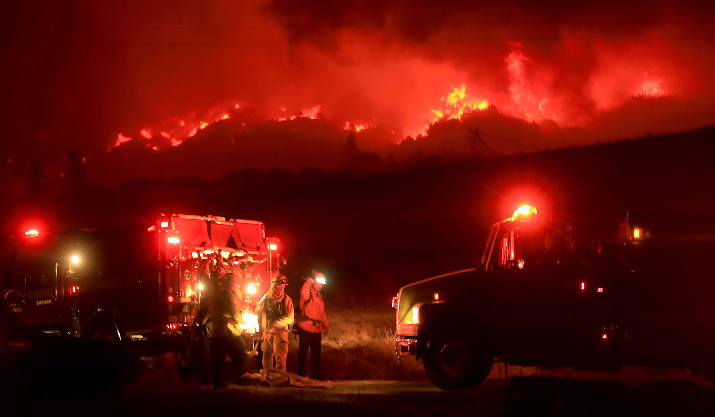 Firefighters prepare to defend their ground as the Kincade spreads down Black Mountain in the Geysers, Thursday, Oct. 24, 2019, in Sonoma County, Calif. (Kent Porter/The Press Democrat via AP)