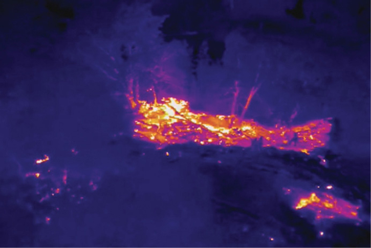 Thermal imaging views streamed to command help them decide where to land fire crews off of rescue boats for a fire on an island in the middle of the Sacramento River at night in Sacramento, California. 