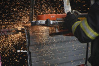 A firefighter operating a saw at the scene