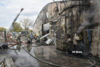 Firefighters operating hose streams on the exterior of the building