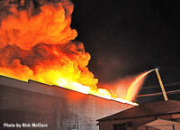 Flames shoot skyward from the fire building