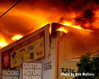 A crack in the building with flames showing through