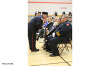 A flag is presented to the widow of the fallen firefighter