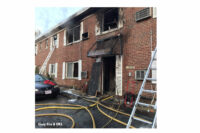 Photo shows laddering and line placement at the fire as well as damage to the building.