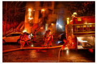 Firefighters pull lines at the scene of the fire in the city of Troy, New York.