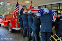 Firefighters remove the casket from the rig.