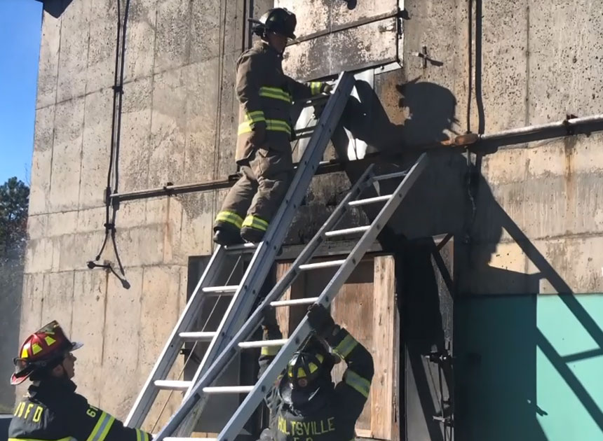 Firefighters raising ladders