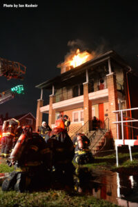 Firefighters mask up on scene of the fire.