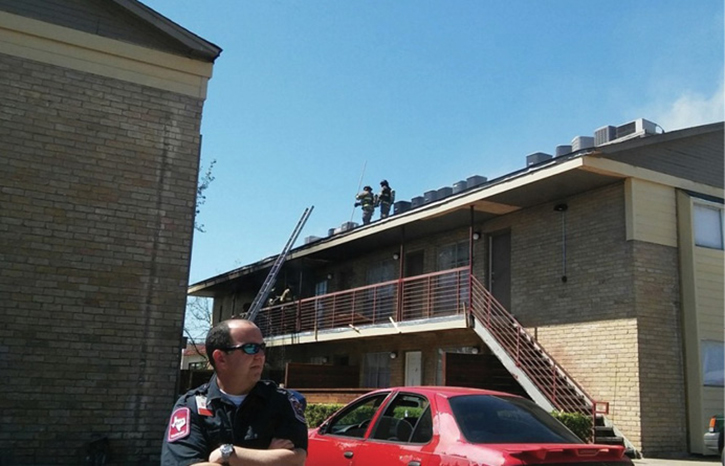 Firefighters attempted to access the fire below the peaked roof. [Photos courtesy of the Greenville (TX) Fire Department.]