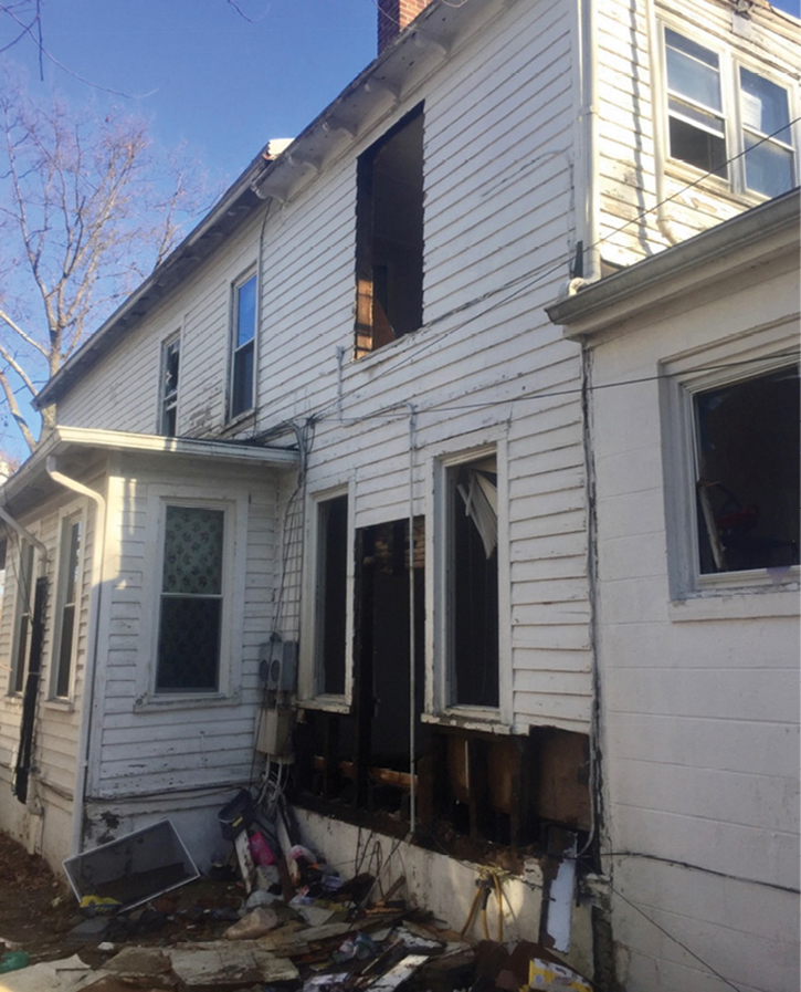 This fire in a crawlspace occurred in a balloon-frame duplex in Mount Holly Township, New Jersey, in February 2018. This was a natural gas-fed fire from a ¾-inch flexible gas line that was compromised by fire. The gas line ran from the full basement of the original foundation of the residence to the additions in the rear. Note the changes in the roof line and exterior building material where the two additions were located. (Photos by Lieutenant Bryan Iannacone.)