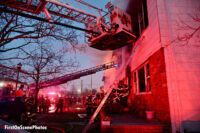 A view of various ladders and apparatus at the fire scene