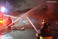 Firefighters apply water to the fire