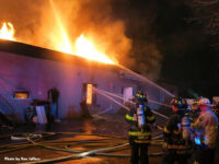 Multiple streams in use as fire vents through the roof of the structure.