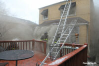 Multiple ladders deployed at the fire scene