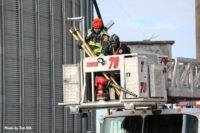 Firefighters in a tower ladder bucket during the rescue operation