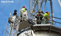 Firefighters make access to the grain bin