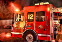 Fire apparatus with light from the flames reflecting on it