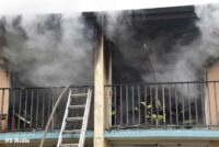 Hose stretched up ground ladder to location in motel