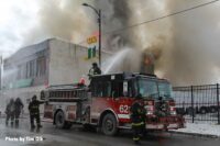 Chicago fire apparatus with firefighter using a deck gun