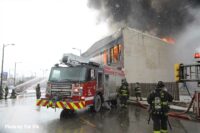 Chicago firefighters and fire truck with burning building