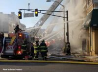 Firefighters and aerial apparatus on the fireground