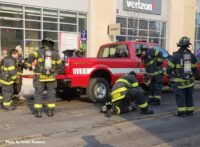 Firefighters ready gear at the scene