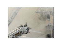 Firefighters in tower ladder buckets battling a major fire in Orlando, Florida.