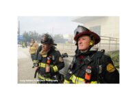 During a break in the action Orlando crew members watch the fireground