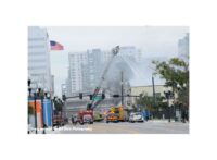 View of building and tower ladders working at the scene