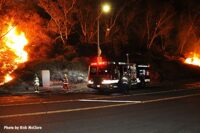 Firefighters and a fire truck at a brush fire