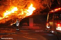 LAFD firefighters at the scene of a fire blazing in vegetation