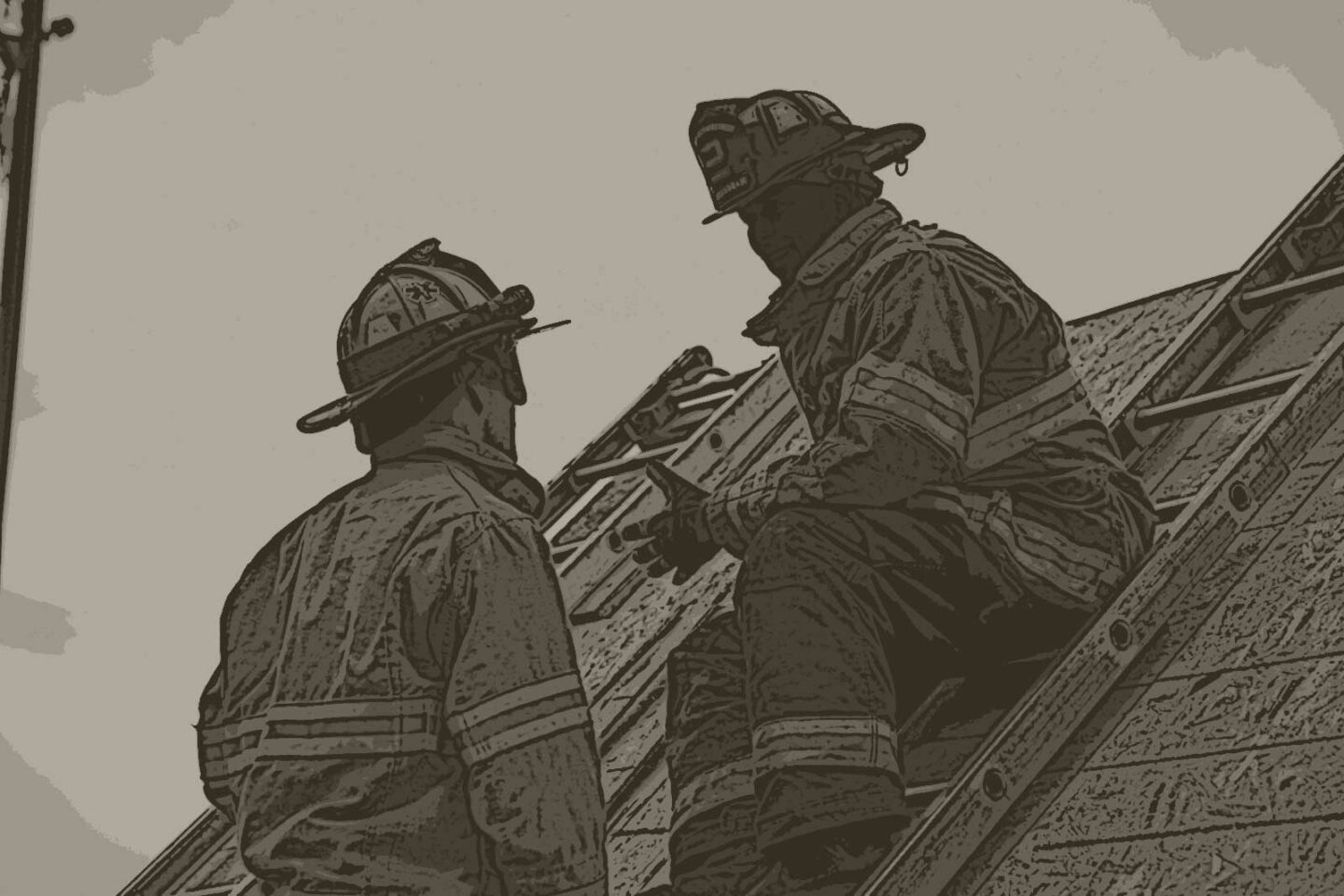 Firefighter on a ladder talking to another firefighter