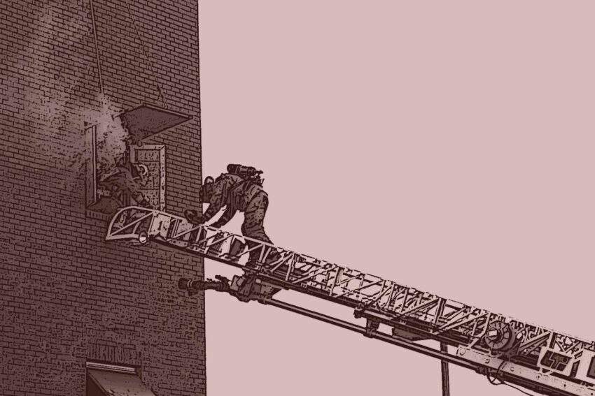 Firefighters climbing an aerial ladder