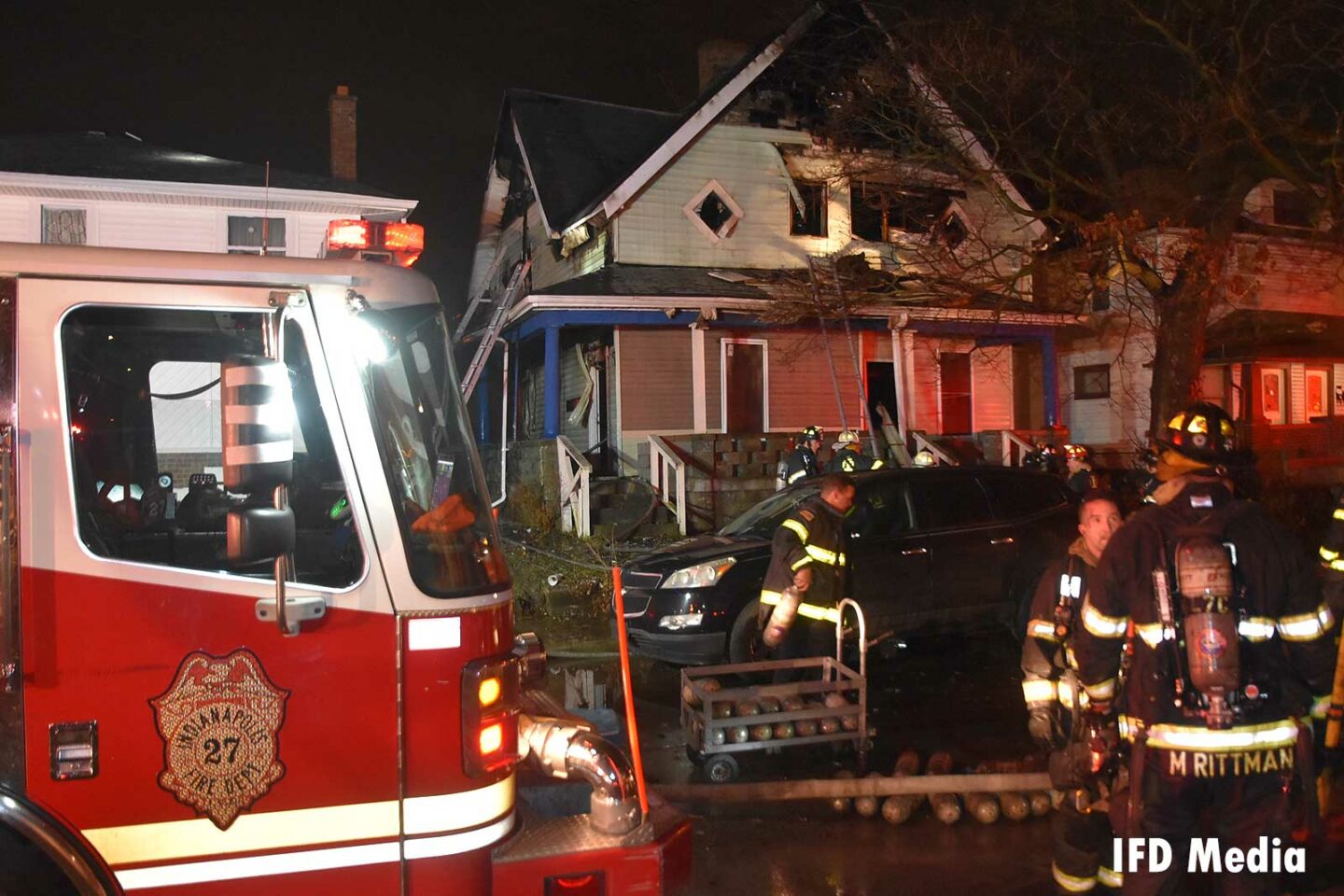 Indianapolis fire truck and firefighters at the scene of a structure fire