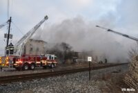 Multiple fire trucks and firefighters on scene of the fire in Indianapolis