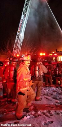 Firefighters and raised aerial device at scene of Buffalo fire