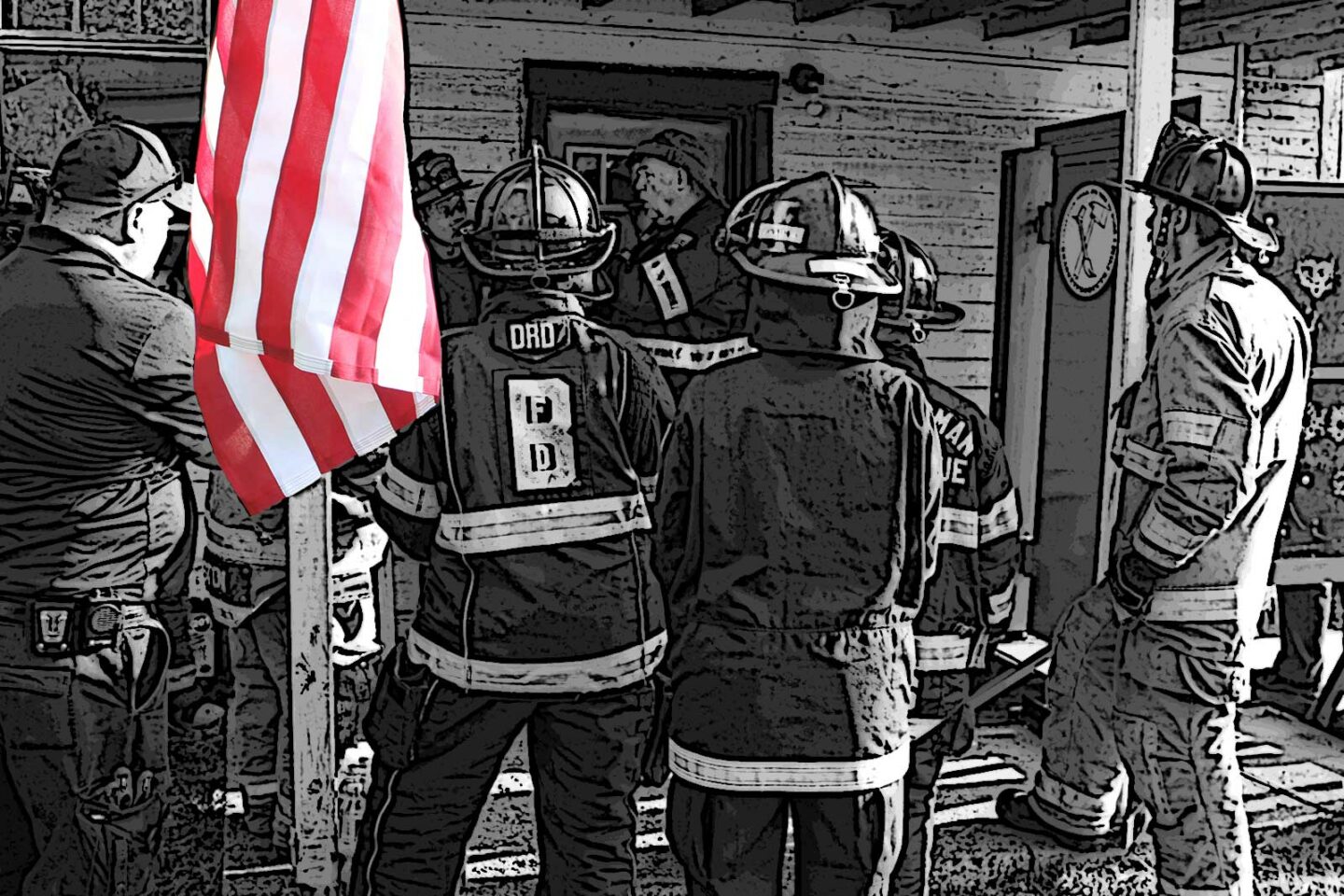 Firefighters stand on a porch with an American flag