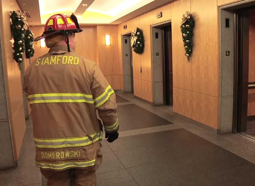 A firefighter using elevators