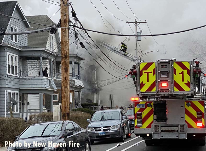 Firefighter on aerial ladder at New Haven fire