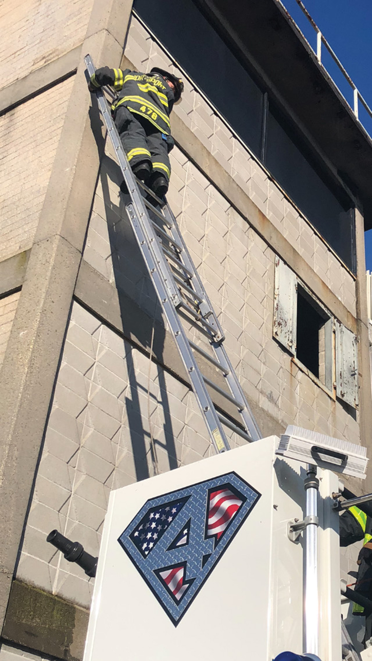 The portable ladder is resting on the rung, simulating the rescue of a victim in a tree, which you may have to do in a lifesaving operation. Always inspect ladders after their use.