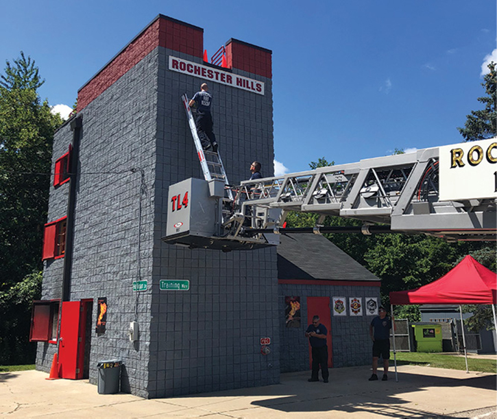 You may have to extend the tower ladder boom under an overhead obstruction and may not be able to increase its elevation, so you may have to use the portable ladder to complete the rescue operation.