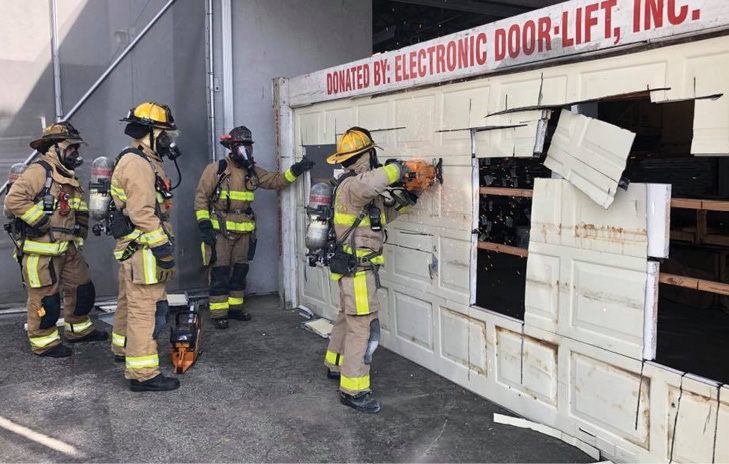 Firefighters cutting a garage door prop