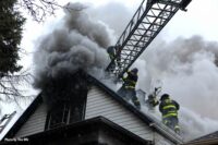 Firefighters perform roof ventilation at a Chicago fire