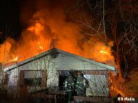 Flames vent from the roof of an abandoned home in Indianapolis