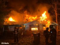 Fire venting from a roof at the Indianapolis house fire