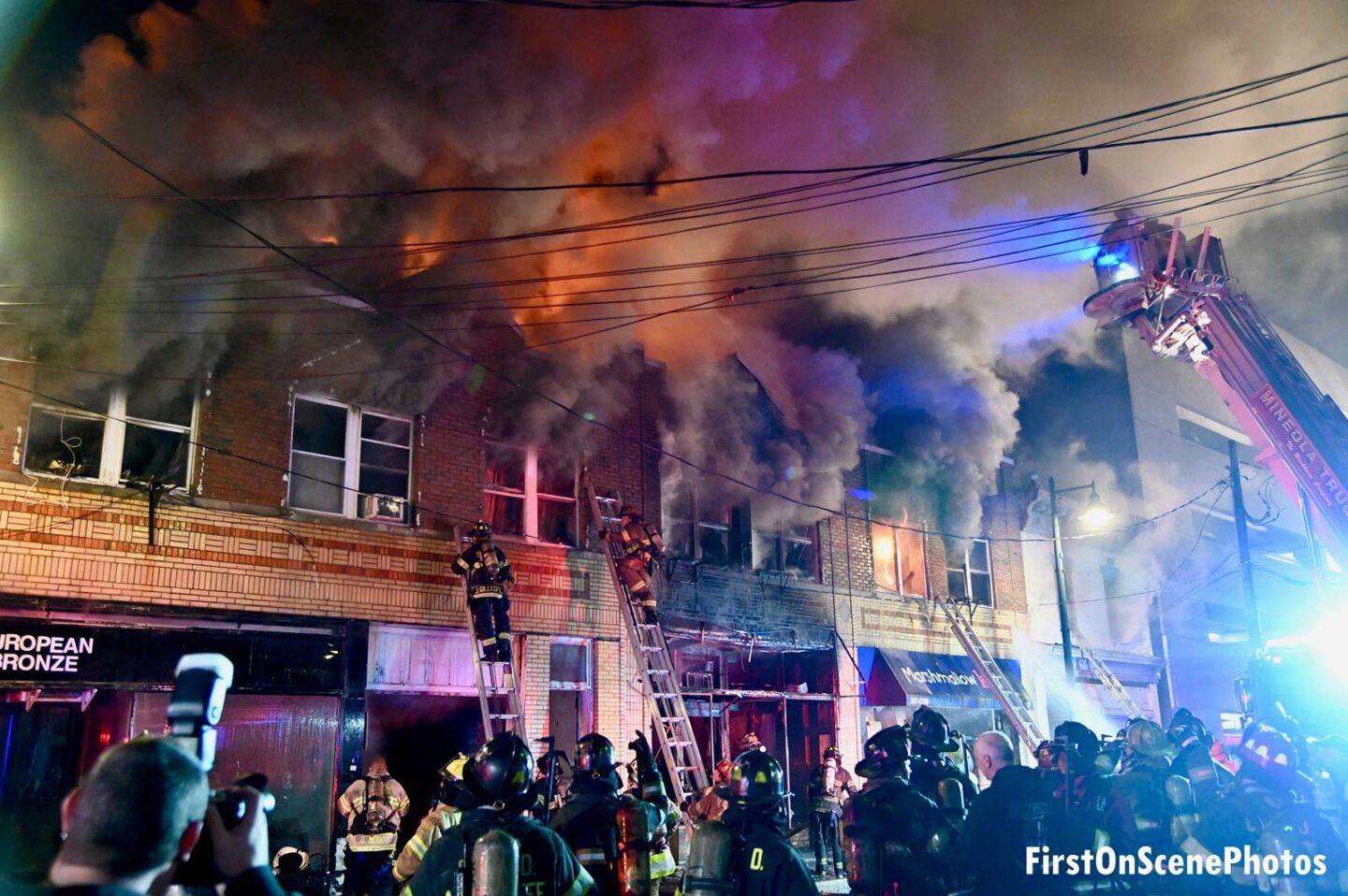 Flames and smoke rage through a row of stores