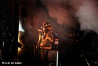 A firefighter with an ax working on the fireground