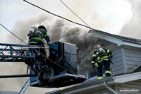 Firefighters in a bucket at a Long Island house fire