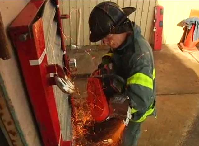 FDNY Catpain Bob Morris using rotary saw on padlocks